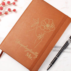 Havijo Unapologetically Me leather journal with a textured brown cover and vintage-style metal clasp, open to reveal blank paper pages.