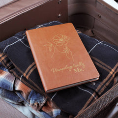 Havijo Unapologetically Me leather journal with textured brown cover and stitched edges, open to show lined pages inside.