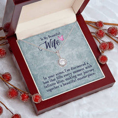 Havijo "In My Wife's Arms" eternal hope necklace featuring a delicate pendant displayed on a jewelry stand.