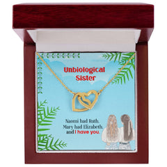 Havijo Best Friends interlocking hearts necklace featuring two silver heart pendants connected together in a jewelry display