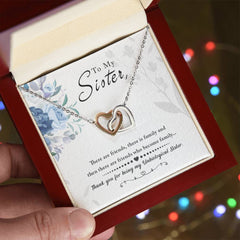 Havijo To My Sister interlocking hearts necklace, silver jewelry with two heart pendants symbolizing love and sisterhood.
