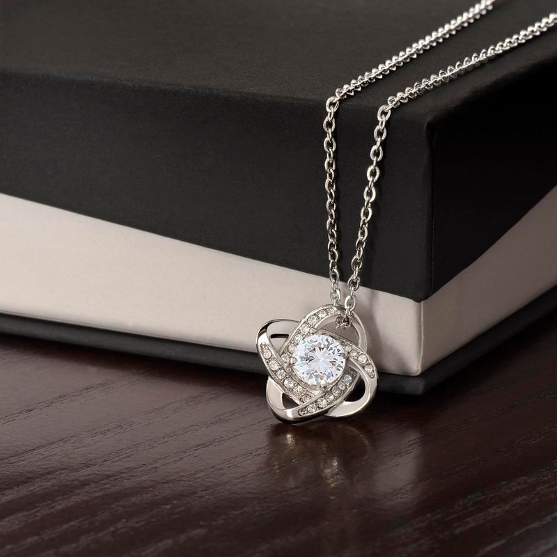 Havijo Love Knot Necklace made of silver with a delicate intertwined design, displayed on a neutral background.