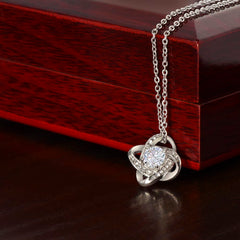 Havijo Love Knot necklace showcasing a delicate silver jewelry piece with an intricate knot design on a white background.