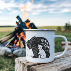 Havijo Mama Bear camping mug jewelry, silver pendant with engraved bear design, on a chain, outdoor camping background.